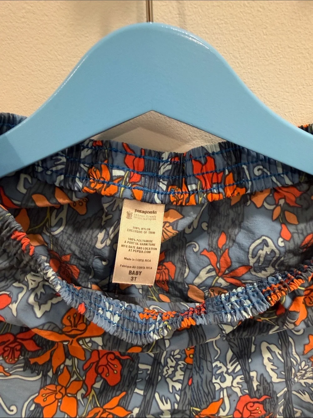Patagonia Kids Blue Swim Trunks with Orange Floral Print